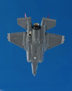 F-35A flying under a bright blue sky
