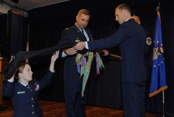 Col John "Face" Hanna unfurls the 61st Fighter Squadron flag