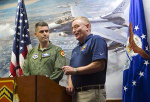 Colonel Robert Webb (left), vice commander of the 56th Fighter Wing, and Rusty Mitchell, director of the Community Initiatives Team with Luke Air Force Base, announce that Luke has been chosen as a training center for F-35 pilots on Aug. 1, 2012.