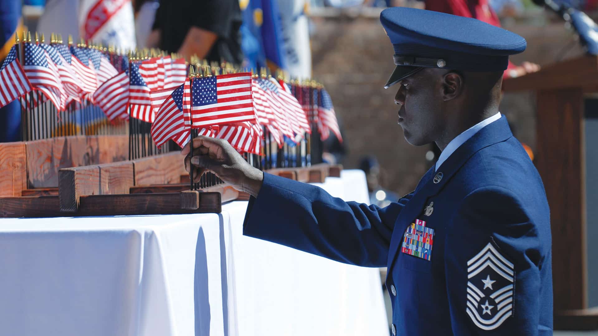 Chief Wicks places an American flag at a USAF ceremony