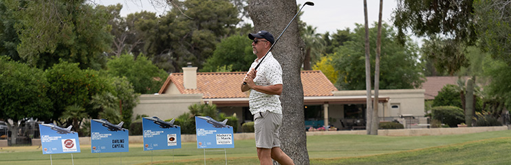 Playing watching his ball playing golf at the FCF golf classic.