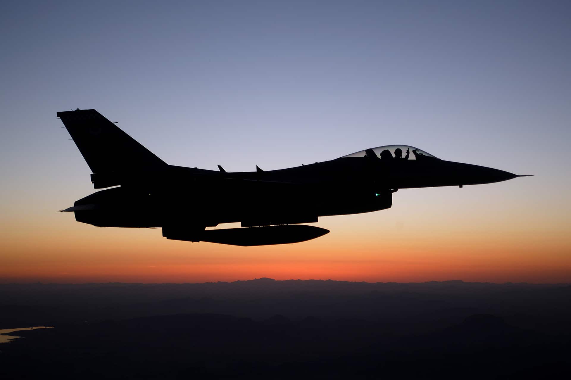 Luke AFB F-16 flying at dusk.