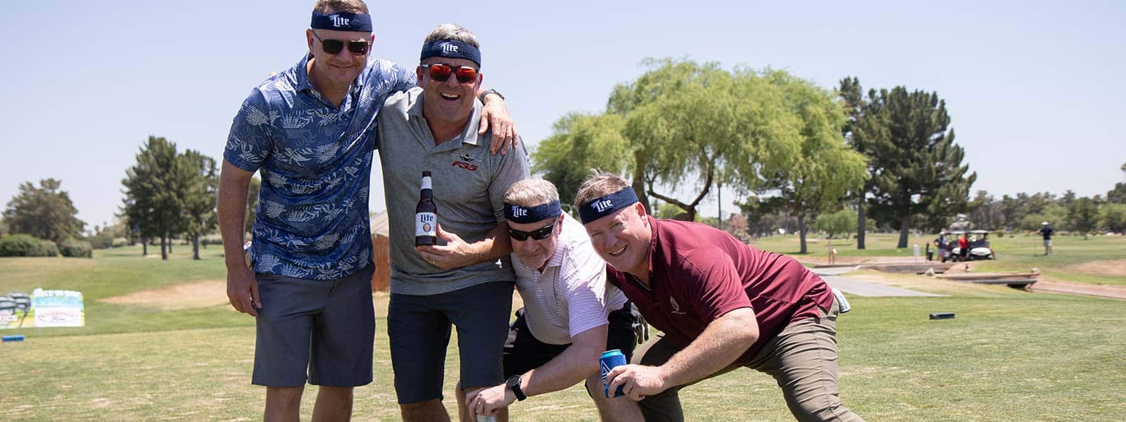 2024 golfers pose for a funny photo op.